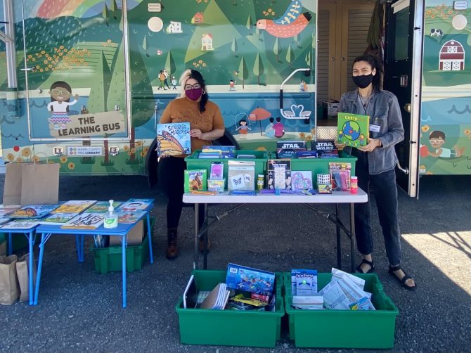 learning-bus-covid Alejandra & Maribel distributing free books and materials at Mesa Park in Bolinas.